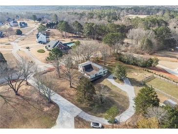 Expansive property featuring a long driveway and mature trees in a serene, established neighborhood at 4951 Center Hill Church Rd, Loganville, GA 30052