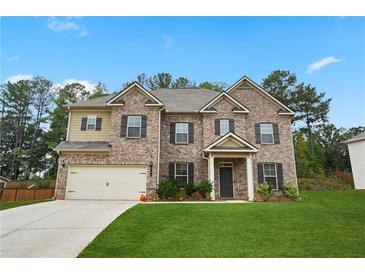 Charming two-story brick home with a well-manicured lawn and inviting entrance at 164 Charolais Dr, Mcdonough, GA 30252