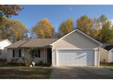 Charming single-story home with a well-manicured lawn and attached two car garage at 244 Amelia Garden Way, Lawrenceville, GA 30045