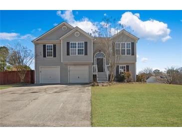 Charming two-story home with a two-car garage, well-manicured lawn, and inviting curb appeal at 6279 Nellie Se Br, Mableton, GA 30126