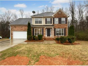 Charming two-story brick home featuring an attached garage and well-maintained landscaping at 641 Morningside Dr, Stockbridge, GA 30281