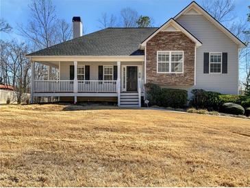 Charming home featuring a welcoming front porch and a mix of stone and siding accents at 63 Avery Way, Dallas, GA 30157