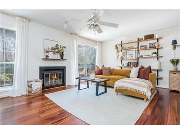 Bright living room features a cozy fireplace, sliding glass doors, and stylish decor at 1323 Weatherstone Ne Way, Atlanta, GA 30324