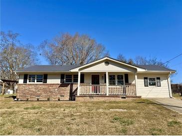 Charming single-story home with brick accents, a covered porch, and a well-maintained front yard at 1091 Mountain View Nw Rd, Conyers, GA 30012