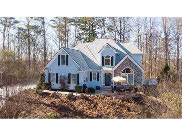 Charming two-story home with blue siding, stone accents, and a well-manicured front yard at 210 Wrights Mill Way, Canton, GA 30115