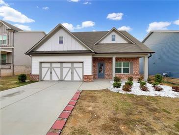 Charming single-Gathering home with a brick and white facade, and a two-car garage at 507 N Gwinnett St, Buford, GA 30518