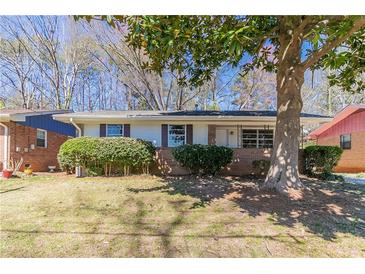 Charming single-story home with brick accents, well-maintained landscaping and a mature shade tree in the front yard at 4051 Ester Sw Dr, Atlanta, GA 30331