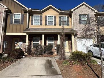 Charming townhome featuring a welcoming entryway, a private garage, and beautiful landscaping at 1970 Old Dogwood, Jonesboro, GA 30238