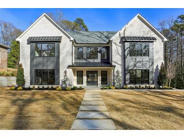 Stunning two-story home with a stone walkway, a manicured lawn, and a modern facade at 372 Karen Dr, Alpharetta, GA 30009