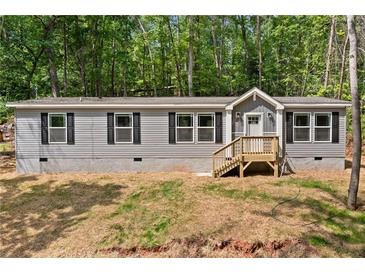 Charming home with gray siding, black shutters and a well-manicured lawn, perfect for suburban living at 160 Vandiver Rd, Canton, GA 30114