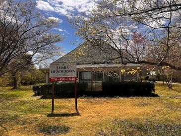 Exterior view of home with sign in front yard and trees surrounding at 3310 Pilgrim Mill Rd, Cumming, GA 30041
