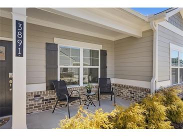 Inviting covered front porch with two chairs and brick accents, perfect for relaxing outdoors at 3891 Shelleydale Dr, Powder Springs, GA 30127