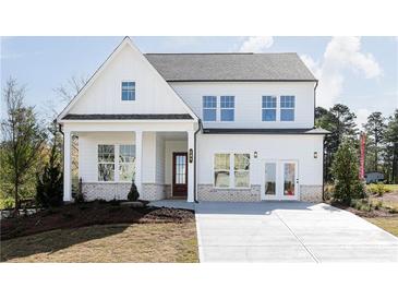 New construction home featuring white siding, a covered porch, and a concrete driveway at 602 Belshire Dr, Acworth, GA 30102