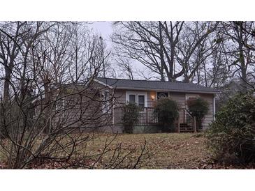 Charming single story house with neutral colored siding, updated roof, and a covered front porch at 5709 Lee St, Morrow, GA 30260