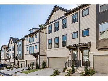 Modern townhome exteriors featuring neutral siding, dark trim, and attached garages, perfect for sophisticated urban living at 1322 Stanley Park Dr, Decatur, GA 30033