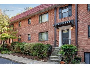 Charming brick townhouse with a red tile roof and well-manicured landscaping at 327 3Rd Ne St # 1, Atlanta, GA 30308