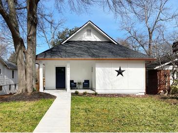 Charming bungalow with a crisp white exterior, black star detail, and a welcoming walkway at 1416 Mcpherson Se Ave, Atlanta, GA 30316