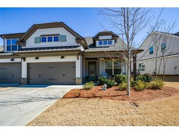 Charming home featuring a two-car garage, tidy landscaping, and inviting curb appeal at 223 Misty View Dr, Canton, GA 30114