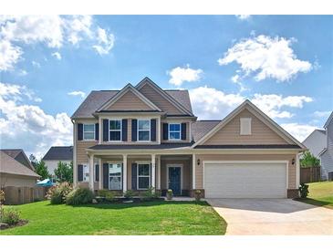 Charming two-story home with well-maintained lawn and attached two-car garage on a sunny day at 39 Clubhouse Way, Acworth, GA 30101