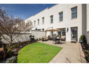 Cozy backyard features a lawn, patio, and outdoor seating, perfect for entertaining at 331 S Esplanade, Alpharetta, GA 30009