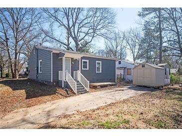 Charming single-story home featuring a concrete driveway and tidy exterior at 1073 Oakland Drive Sw Dr, Atlanta, GA 30310