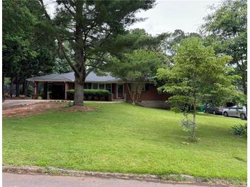 Charming brick home with a well-maintained lawn and mature trees at 4188 Fontana Ct, Tucker, GA 30084