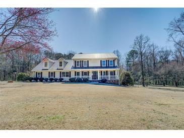 Charming two-story home with a metal roof and inviting front porch at 1103 Wallington Nw Ct, Conyers, GA 30012