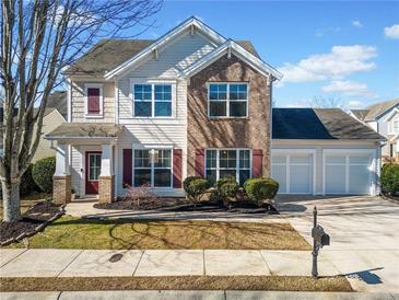 Charming two-story home with a two-car garage, inviting front yard, and classic architectural details at 113 Plumeria St, Canton, GA 30114