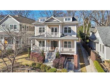 Attractive two-story home with a porch, second story balcony, well-manicured landscaping, and mature trees at 970 Drewry Ne St, Atlanta, GA 30306