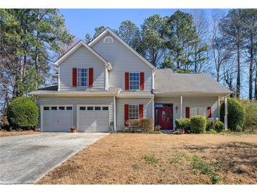 Charming two-story home featuring a two-car garage and mature trees in a serene neighborhood at 1267 Huntington Place Cir, Lithonia, GA 30058