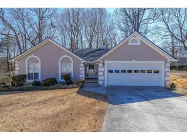 Charming single-story home featuring a two-car garage and well-manicured front yard at 403 Flint Hill Ct, Lawrenceville, GA 30044