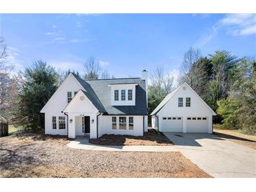Charming two-story home with white siding, black trim, and an attached two-car garage at 2242 Longford Ne Ct, Marietta, GA 30066