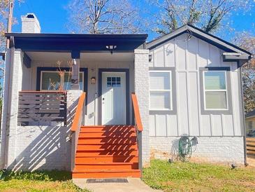 Charming home with painted brick, red steps, modern railings, and a covered porch at 1074 Hobson Sw St, Atlanta, GA 30310