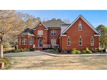 Stately two-story brick home with a manicured lawn and mature landscaping at 238 Chappell Rd, Fayetteville, GA 30215