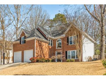 Charming two-story brick home with a two-car garage and well-maintained landscaping at 4872 Thicket Path, Acworth, GA 30102