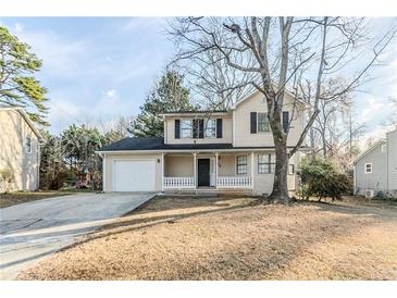 Charming two-story home featuring a cozy front porch and attached garage at 5438 Zachary Dr, Stone Mountain, GA 30083