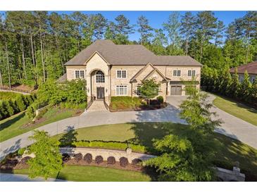 Stunning two-story brick home with meticulously landscaped front yard and circular driveway at 4434 Oglethorpe Nw Loop, Acworth, GA 30101