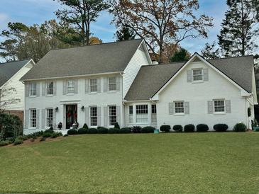 Charming white two-story home with gray shutters and a well-manicured lawn at 5449 Redbark Way, Atlanta, GA 30338