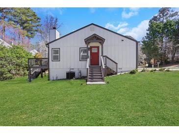Charming home with a red front door, landscaped yard, and inviting entry stairs at 3242 Kingswood Gln, Decatur, GA 30034