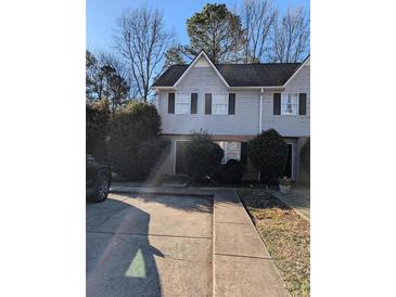 Two-story townhome featuring a gray exterior, black shutters, and a well-maintained front yard with some greenery at 4351 Logan Way, Acworth, GA 30101