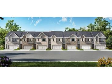 New townhomes boast unique brick and stone exteriors, private garage, and professionally landscaped front yards at 3071 Greyton Dr, Buford, GA 30519