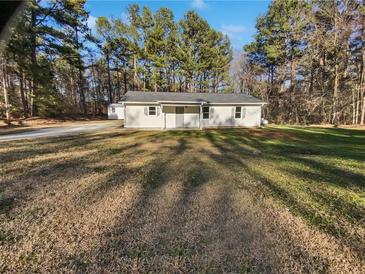 Charming one-story home featuring a spacious front yard and well-maintained landscaping at 3103 Mote Rd, Covington, GA 30016