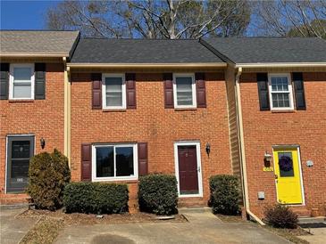 Charming brick townhome featuring a well-maintained front yard and classic architectural details at 1098 Westfield Se Trce, Smyrna, GA 30082