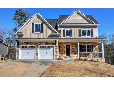 Charming two-story home featuring a two-car garage, stone accents, and a welcoming front porch at 30 Grand Georgian Ne Ct, Cartersville, GA 30121