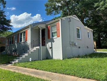 Charming single Gathering home featuring a white brick exterior and bright orange shutters at 725 Casplan Sw St, Atlanta, GA 30310