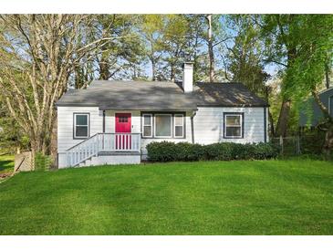 Charming single story home with a red front door and inviting curb appeal at 2132 Penrose Dr, East Point, GA 30344