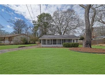 Charming home with a well-maintained lawn and a screened-in front porch, creating a cozy and inviting entrance at 2880 Hall Se Dr, Smyrna, GA 30082