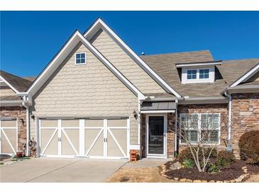 Charming home with a two-car garage, stone accents, and well-maintained landscaping at 312 Overview Dr, Canton, GA 30114