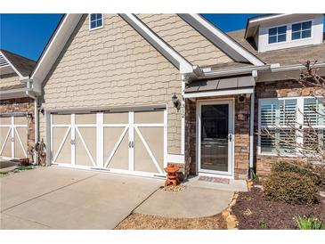 Charming home with a two-car garage, stone accents, and a welcoming front door at 312 Overview Dr, Canton, GA 30114