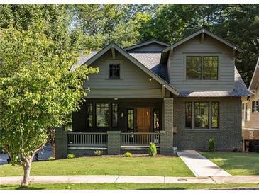 Charming two-story home with a welcoming front porch, lush lawn and professional landscaping at 1563 Westwood Sw Ave, Atlanta, GA 30310